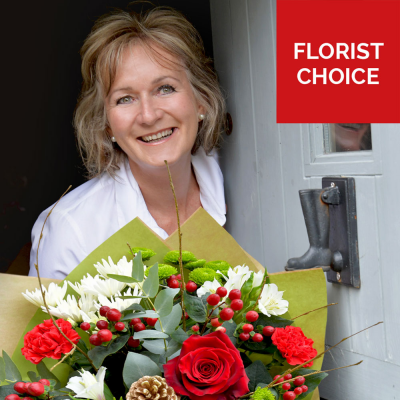 Christmas Florist Choice Hand-Tied - A festive hand-tied filled with the seasonal flowers, perfectly wrapped by the local florist and delivered in water.